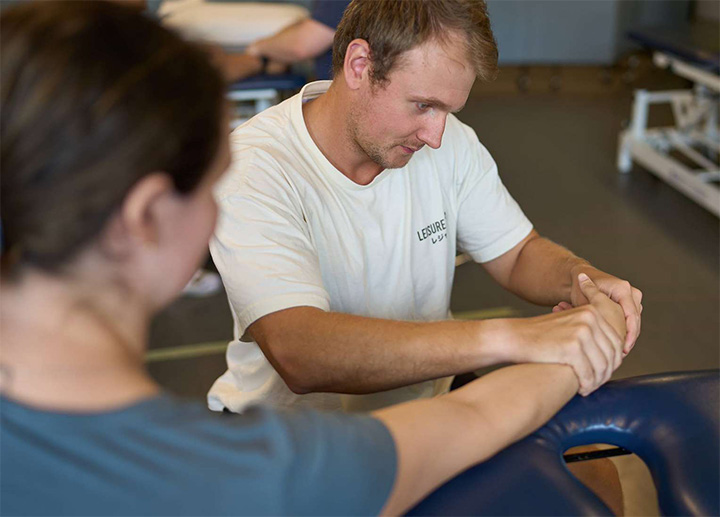 Students in the CMP program practicing arm stretches.