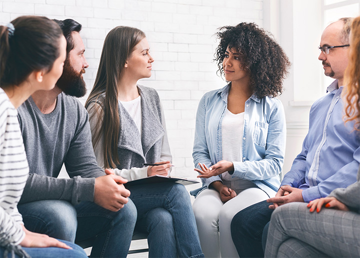 A group of individuals sitting together and having a discussion.
