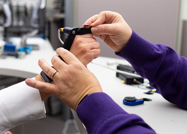A hand therapist assisting a patient.